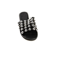 Black flat slide sandals with studded lattice straps and open toe
