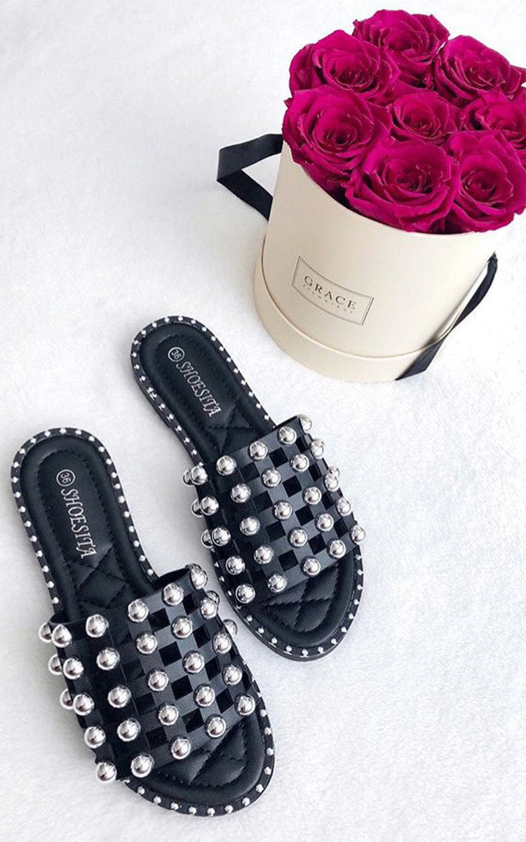 Black studded flat slides with silver lattice straps and open toe