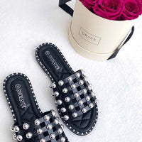 Black studded flat slides with silver lattice straps and open toe