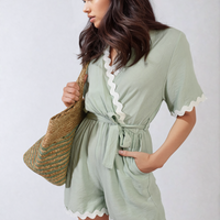 Mint wrap playsuit with scalloped white trim, waist tie and short sleeves