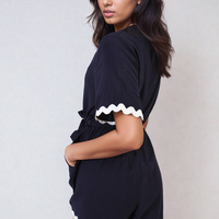 Dark wrap playsuit with contrast scalloped trim and waist tie, short sleeves