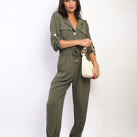 Olive green button-front collar jumpsuit with drawstring waist and relaxed jogger fit.