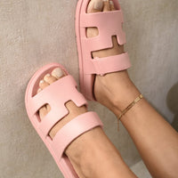 Pink slide sandals with geometric cutout straps and wide band