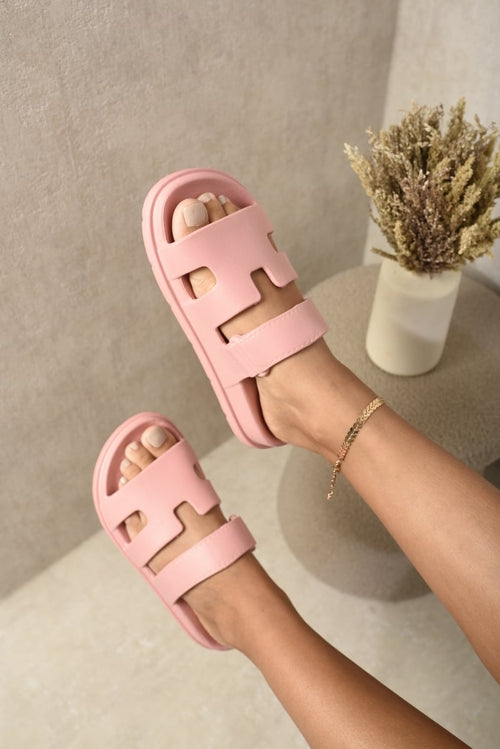 Pink slide sandals with wide geometric straps and open toe