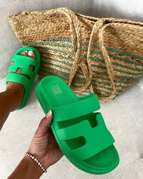 Green slide sandals with chunky sole and geometric cutout straps