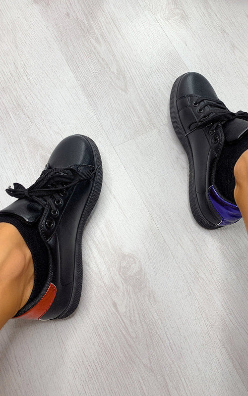 Pair of black lace-up trainers with orange side stripe and textured sole