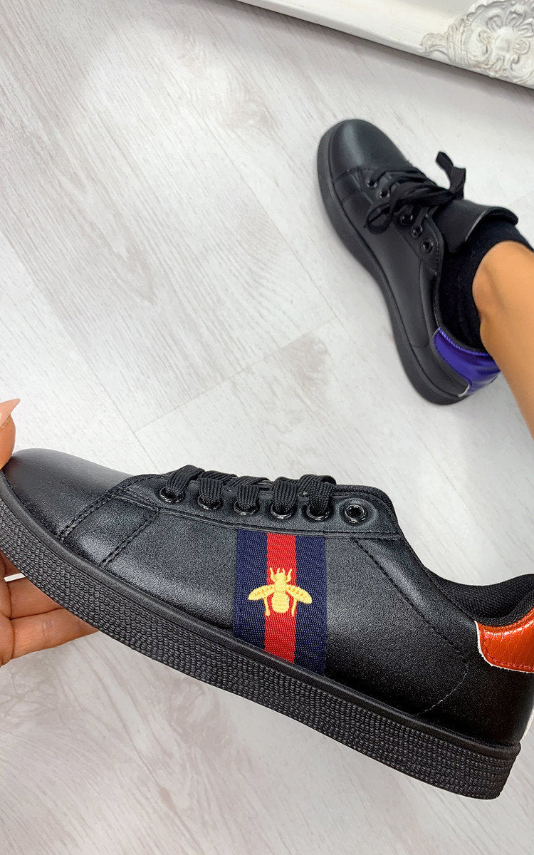 Black trainers with striped side patch and bee emblem, lace-up design