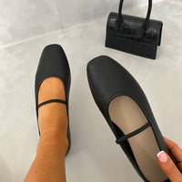 Black round-toe ballet slip-on flats with thin ankle strap, side view