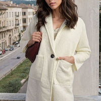 Cream textured button-front long jacket with front patch pockets and notch lapel.