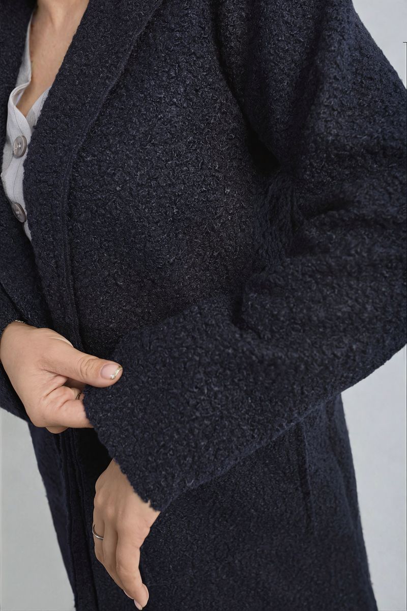 Navy textured button-up jacket detail with front pocket flap and button