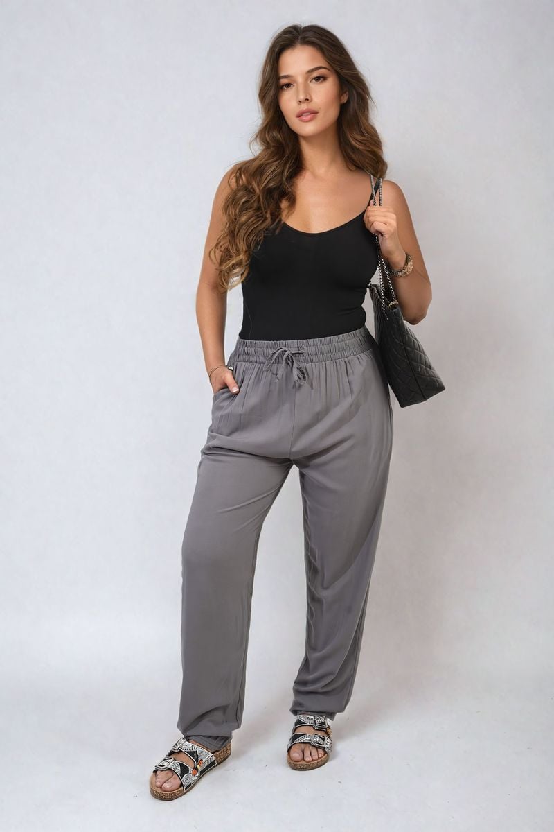 Grey high-waist drawstring trousers with side pockets and gathered waistband.