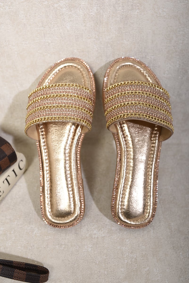 Gold-tone slide sandals with wide embellished straps and glossy metallic footbed