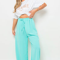 Turquoise drawstring gathered-waist wide-leg trousers with loose relaxed legs