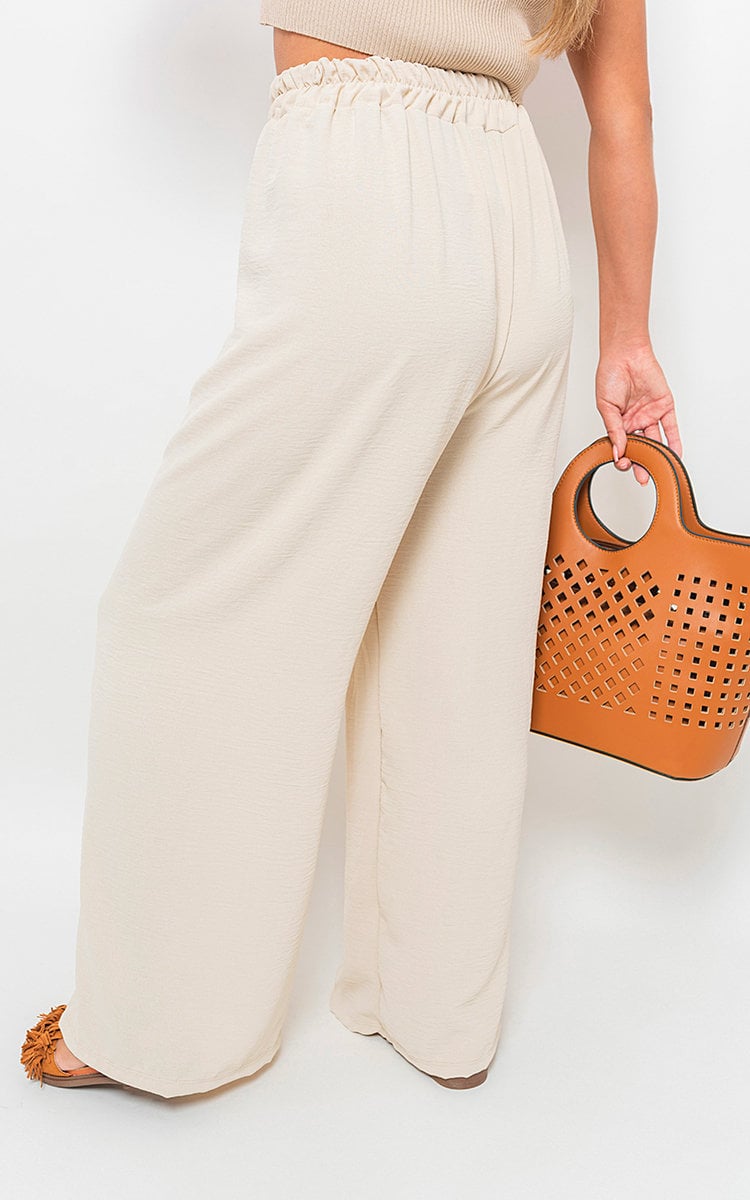 Beige wide-leg trousers with gathered drawstring waist, close side view