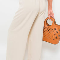 Beige wide-leg trousers with gathered drawstring waist, close side view