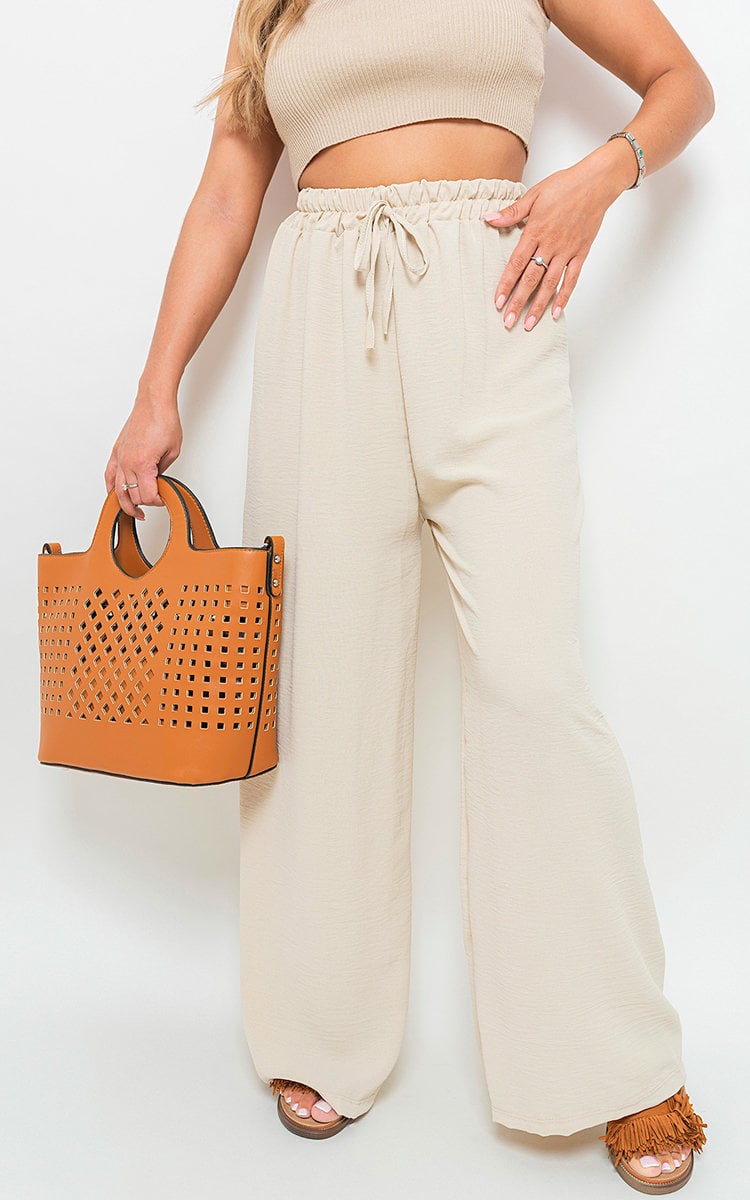 Beige wide-leg trousers with gathered drawstring waist and loose drape