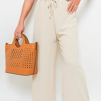 Beige wide-leg trousers with gathered drawstring waist and loose drape