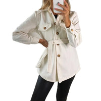 White belted jacket with flap pockets and gold button front, tied waist.