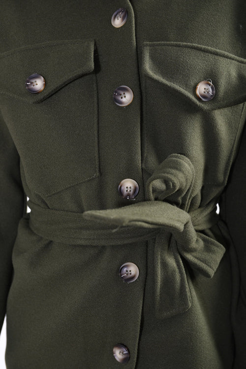 Olive green belted jacket close-up with dark buttons and tie waist.