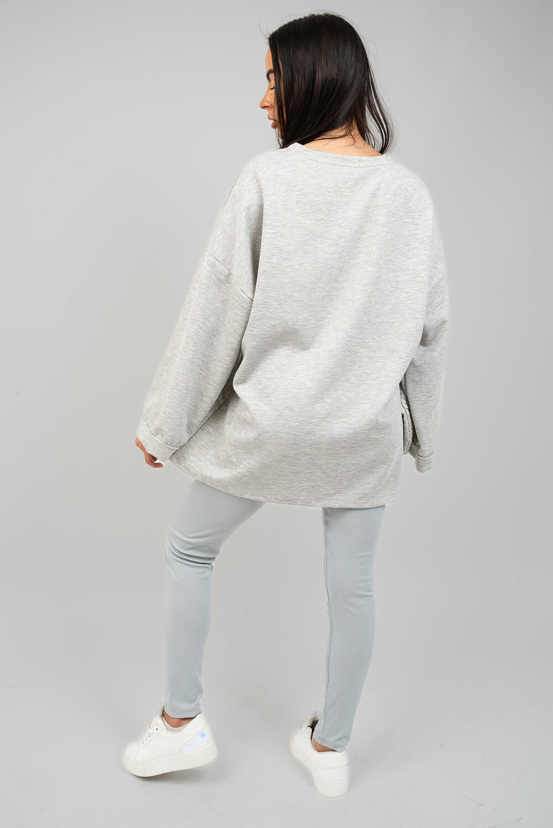 Light grey oversized crewneck sweatshirt with long sleeves, back view