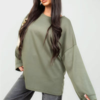 Oversized olive-green sweatshirt with round neck and long sleeves, loose relaxed fit.