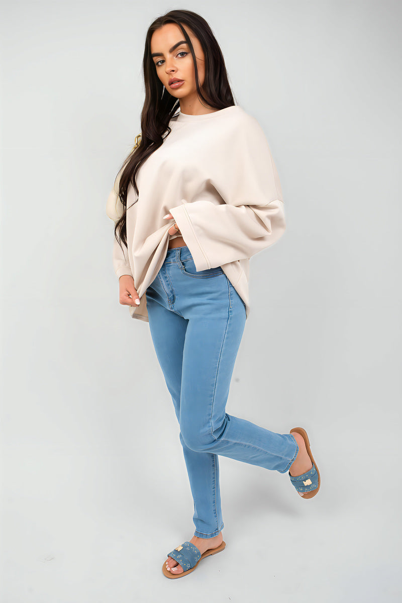Off-white oversized crewneck sweatshirt with long sleeves, side front view