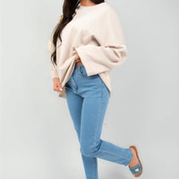 Off-white oversized crewneck sweatshirt with long sleeves, side front view