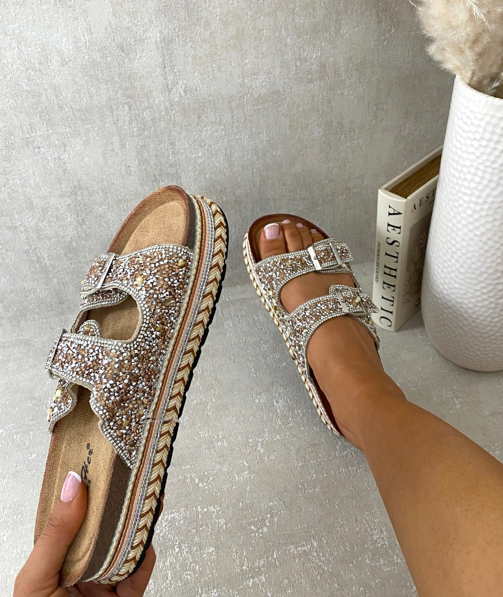 Embellished gold rhinestone platform sandals with double buckle straps and open toe.