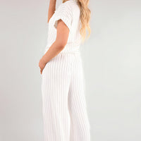 White pinstripe tie-front shirt and wide-leg trousers, side view