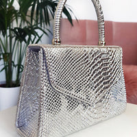 Faux Leather Handbag in Lilac with Top Handle and Chain Strap