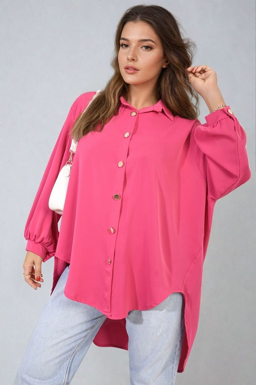 Oversized pink button-down shirt with pointed collar and long sleeves, front buttons
