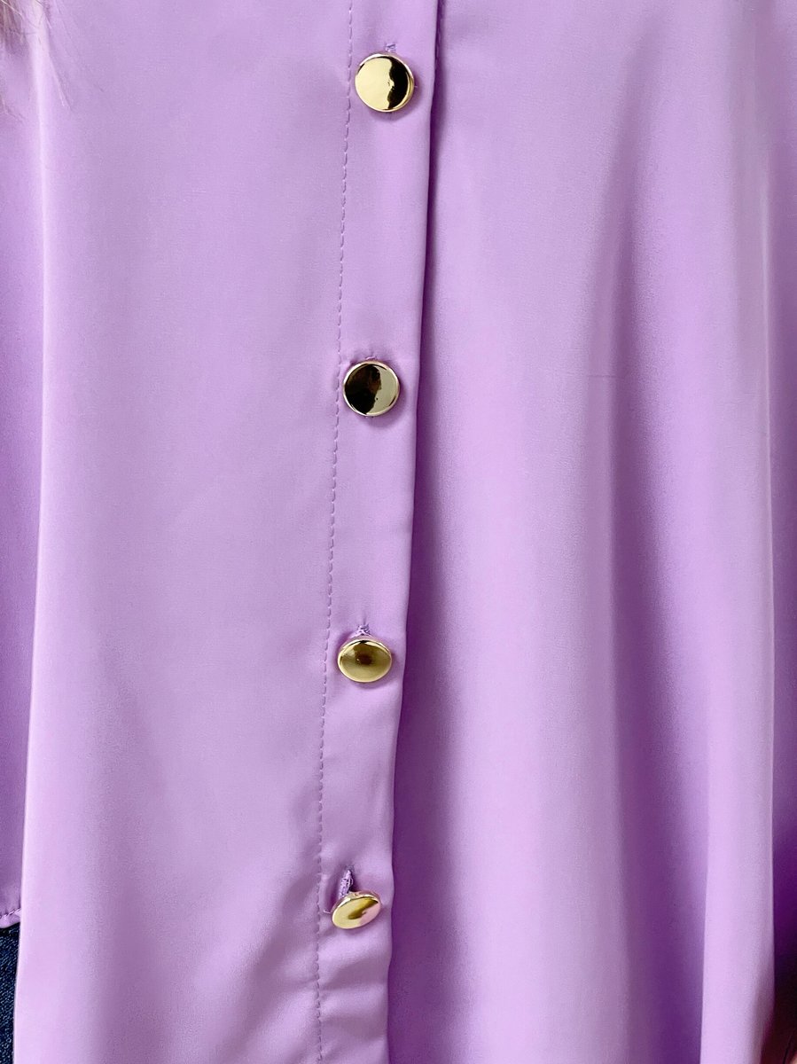 Oversized collared button-down top in lavender with gold round buttons, front placket close-up.