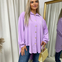 Oversized collared button-down top in lavender, long sleeves with gold buttons and relaxed fit.