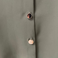 Oversized collared button-down top fabric detail with round metal buttons on the placket.