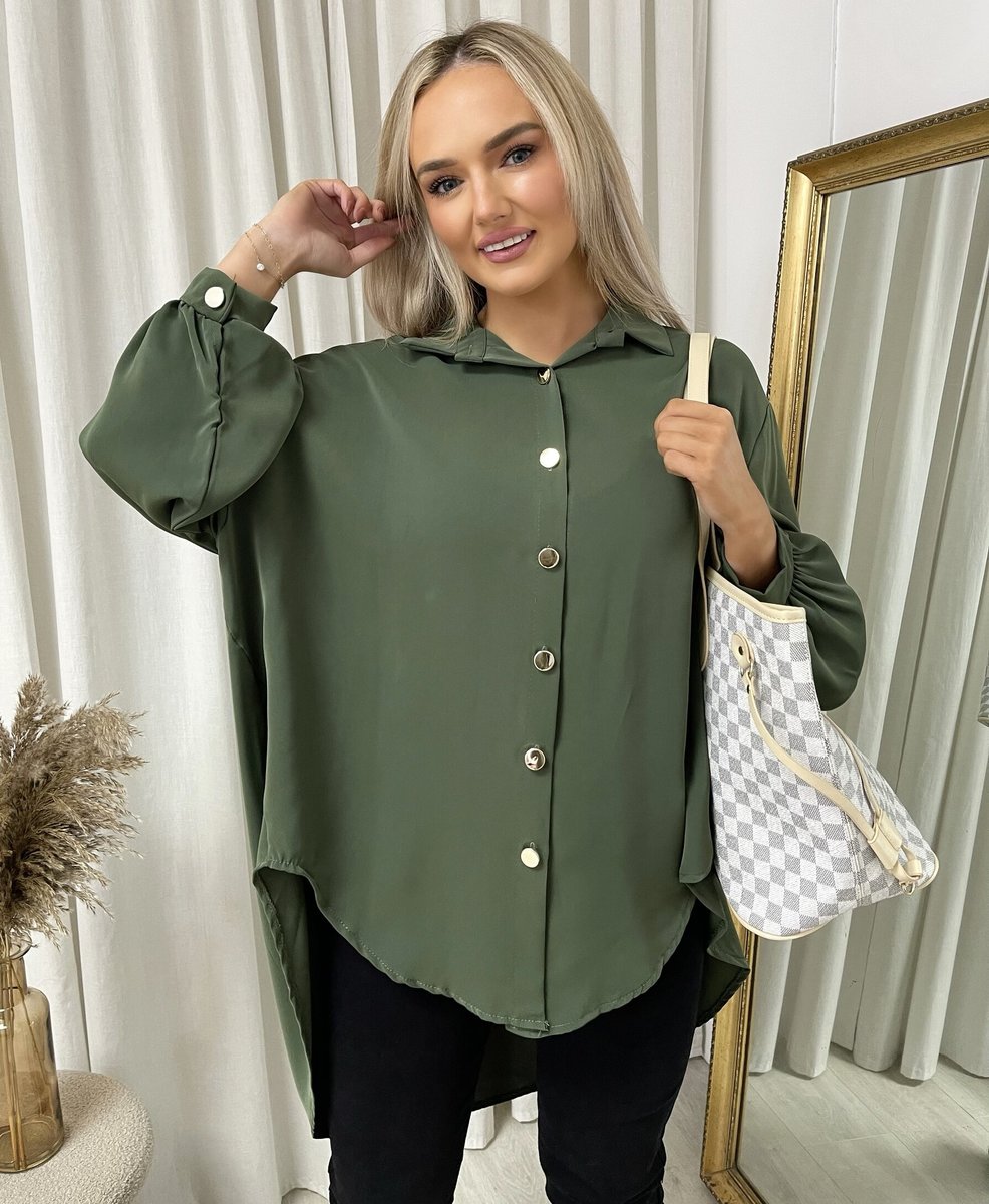 Oversized collared button-down top in dark green with gold buttons and loose long sleeves.