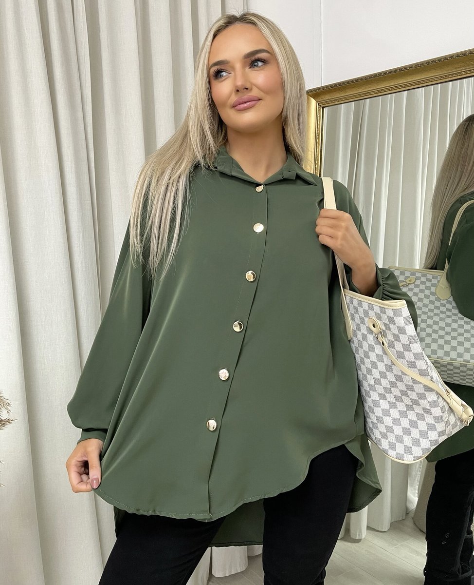 Oversized collared button-down top in dark green with gold buttons, roomy long sleeves.