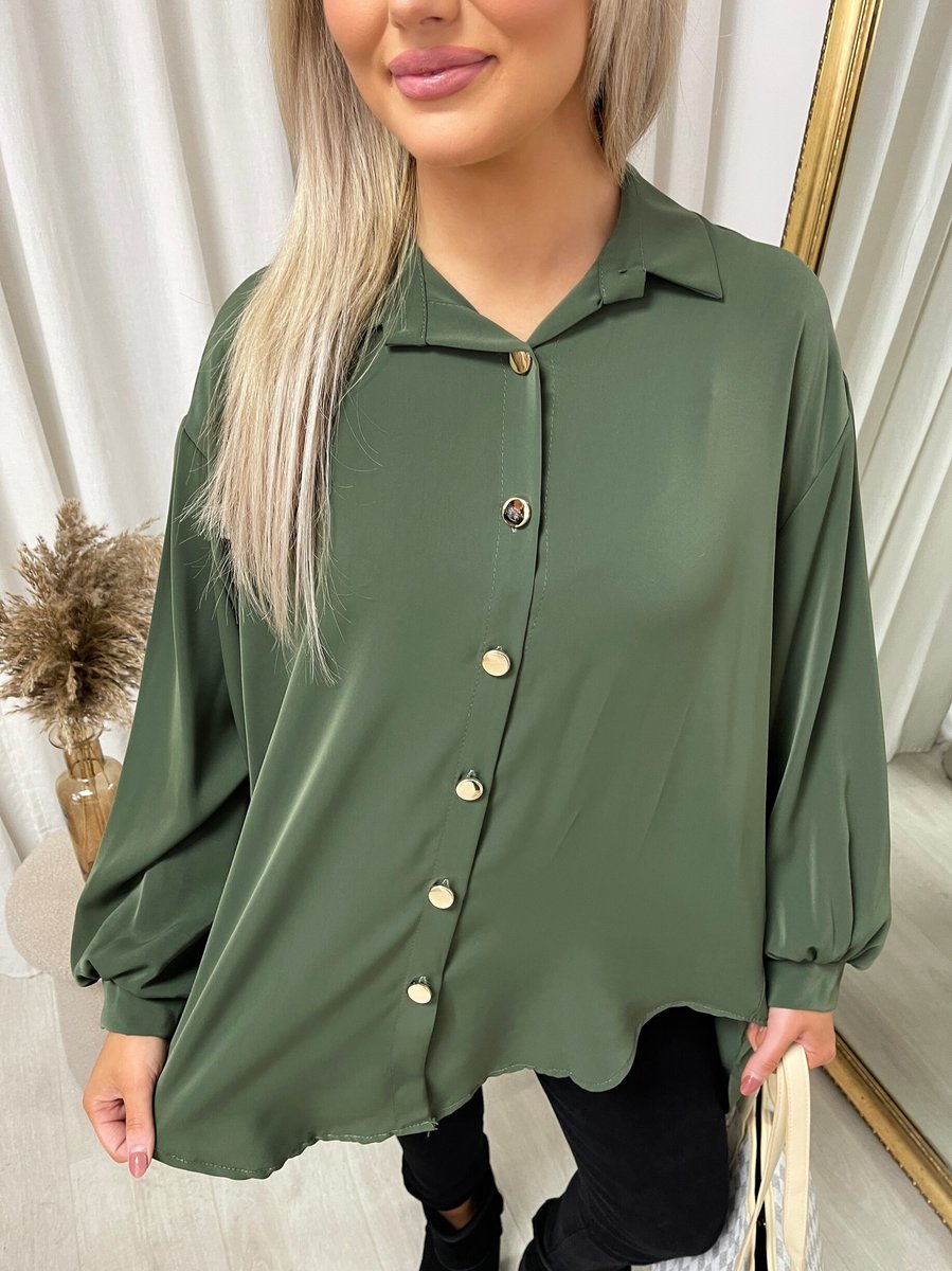 Oversized collared button-down top in dark green, close-up of collar and gold button placket.