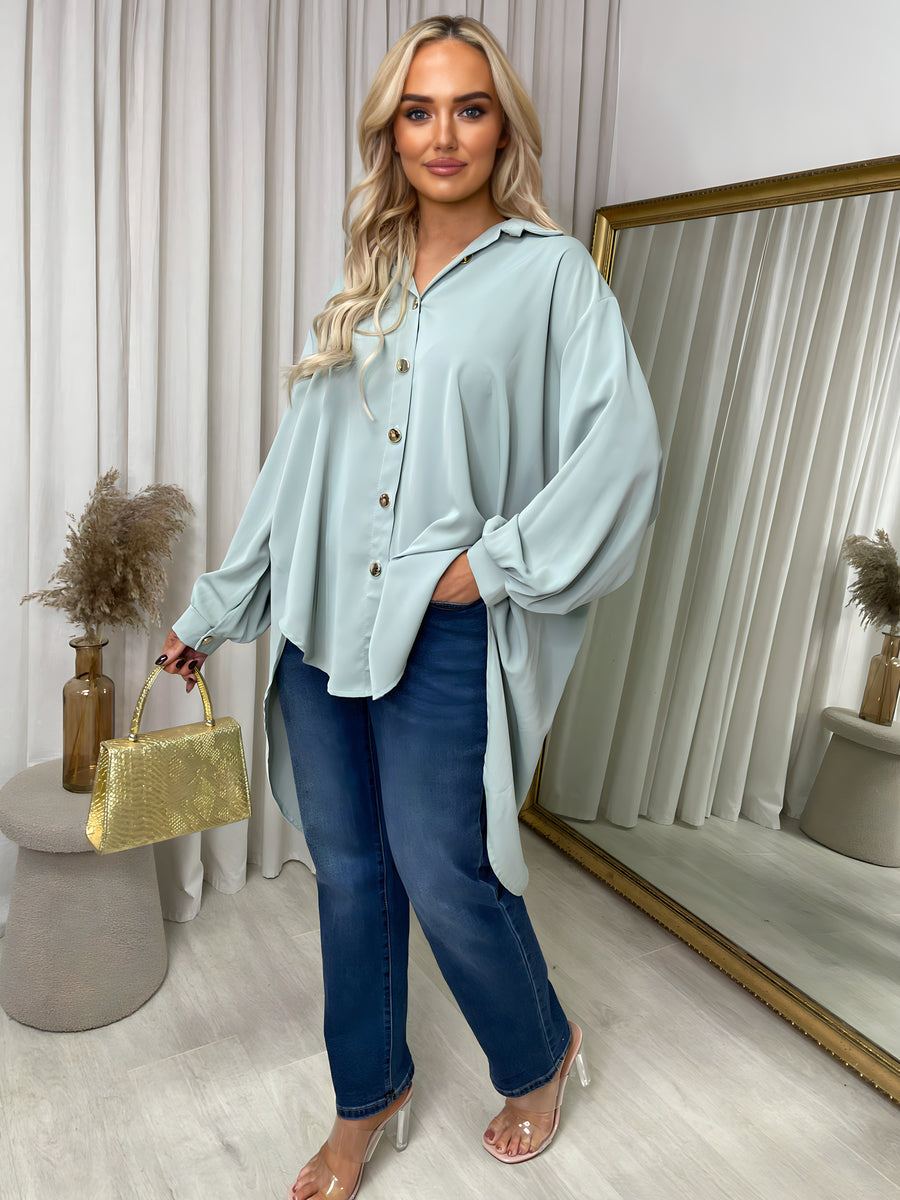 Light blue oversized collared button-down top with long sleeves and button placket