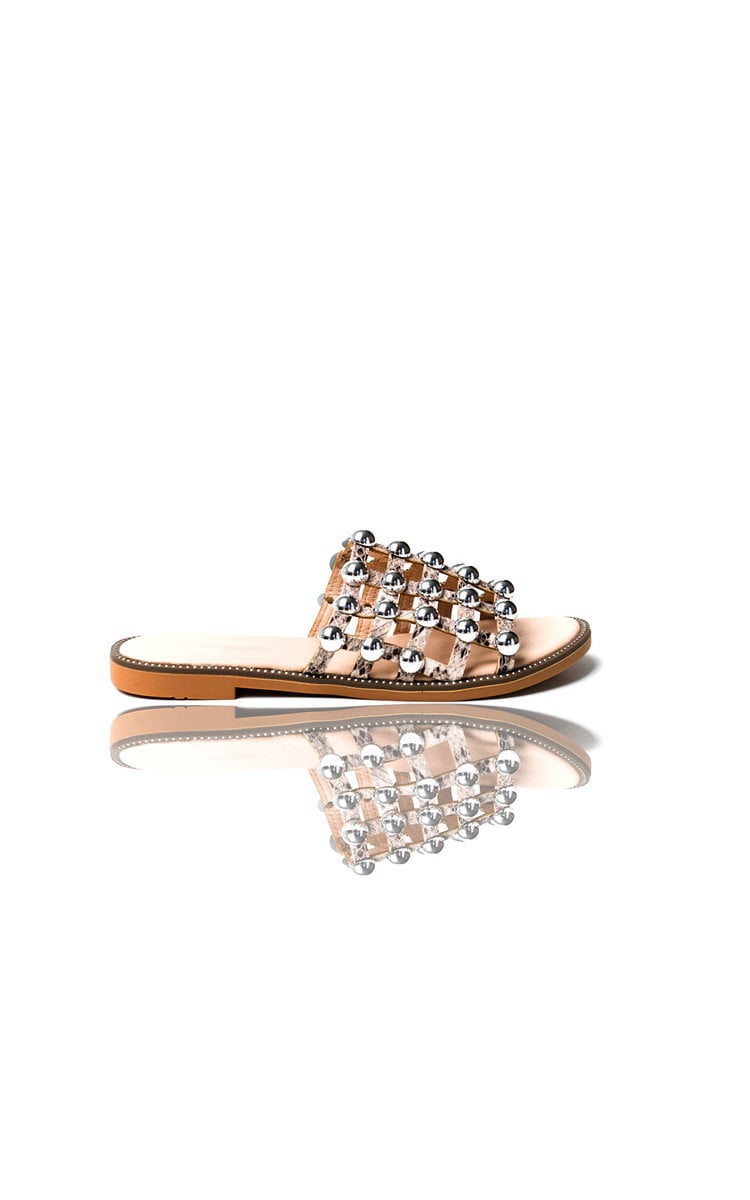 Studded lattice flat slide sandals, jeweled strap and tan sole shown from side