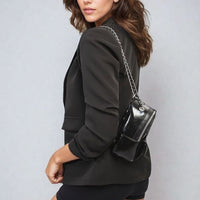 Black open-front blazer with ruched sleeves and front pockets, side view