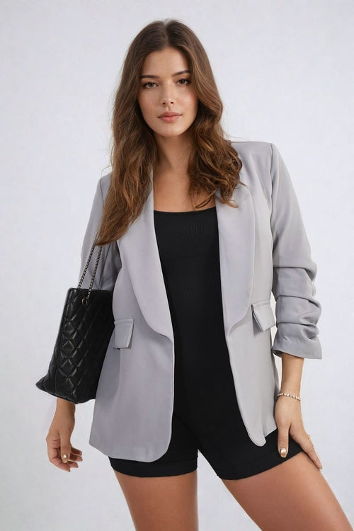 Open-front ruched-sleeve blazer jacket in light gray with front pockets and wide lapels.