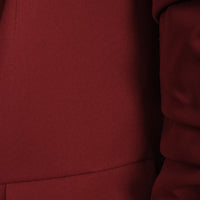 Wine red blazer fabric close-up with seam and ruched sleeve panel