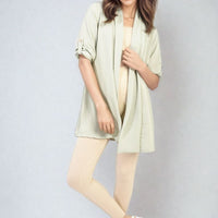 Light green open-front cardigan with roll-up sleeves and relaxed draped fit