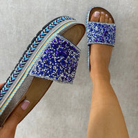 Blue glitter platform slide sandals with braided trim and jeweled strap detail