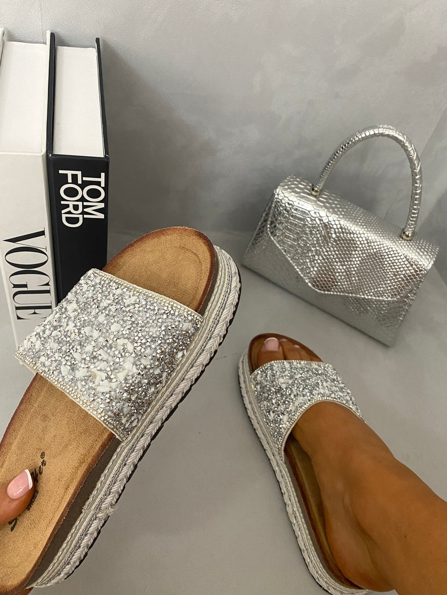 Silver glitter platform slide sandals with textured strap, open toe, and braided sole