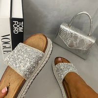 Silver glitter platform slide sandals with textured strap, open toe, and braided sole