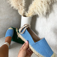 Light blue slip-on espadrille with woven toe cap and adjustable ankle tie