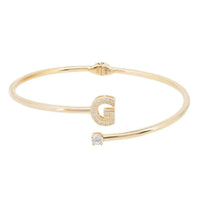 Gold bangle bracelet with square G charm and round stones
