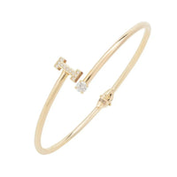 Gold tone initial bangle with clear stone letter I centerpiece