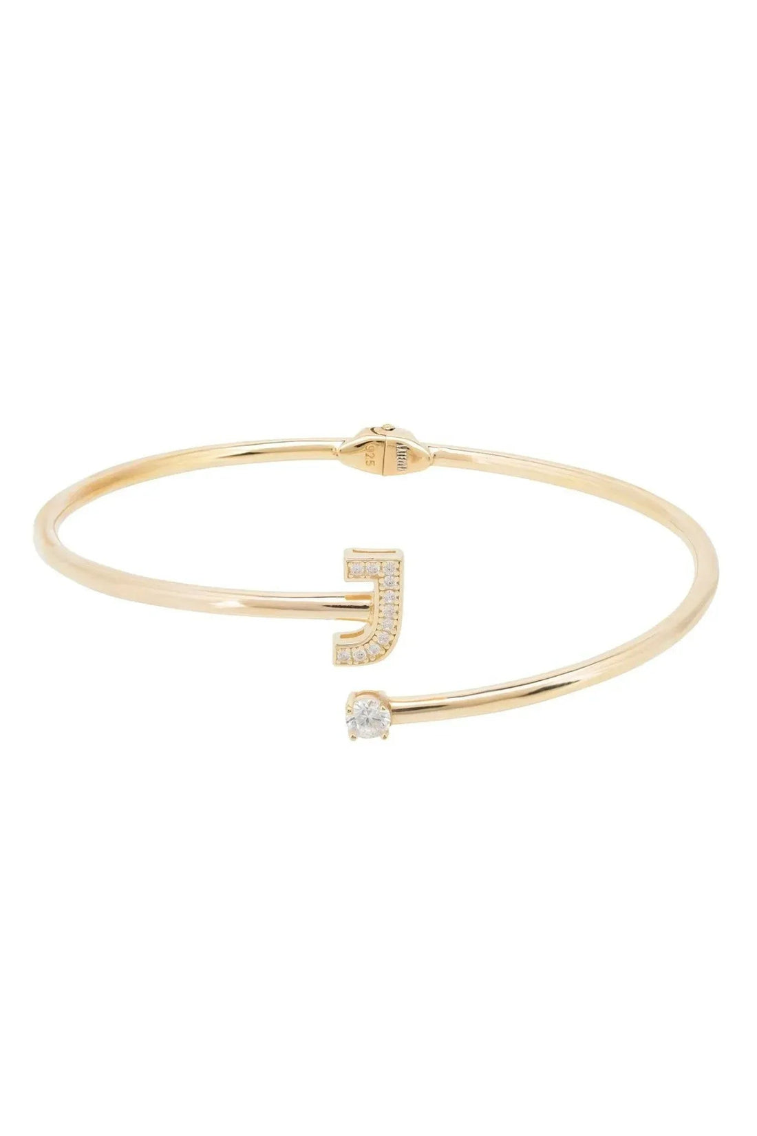 Gold bangle bracelet with J-shaped pavé accent and clear stone detail